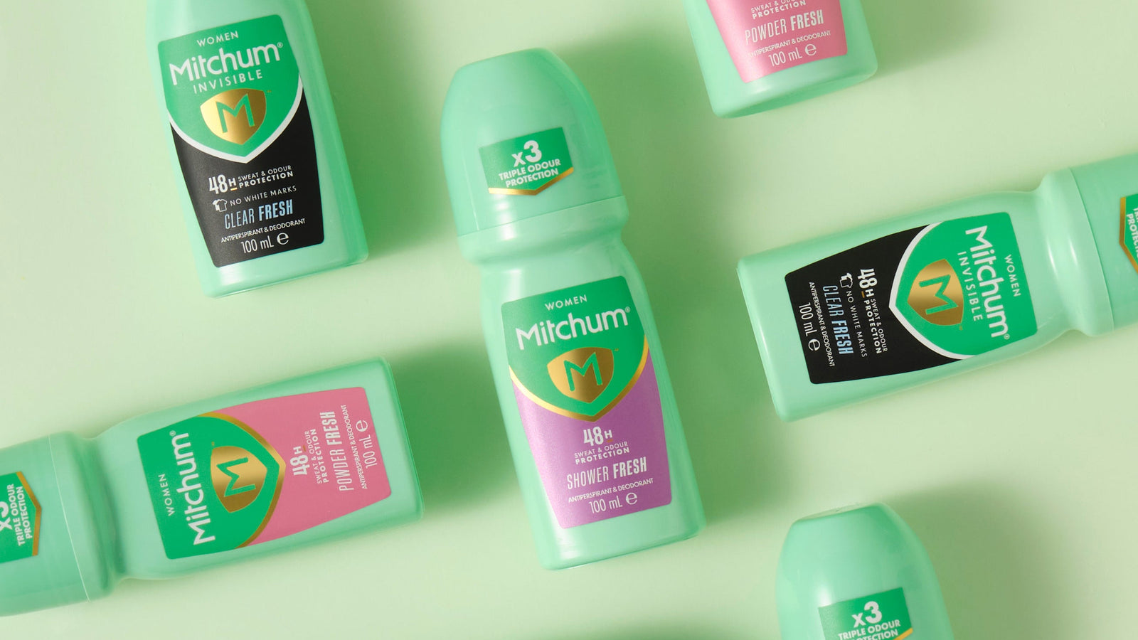 Mitchum roll-on antiperspirant deodorant bottles on a light green background